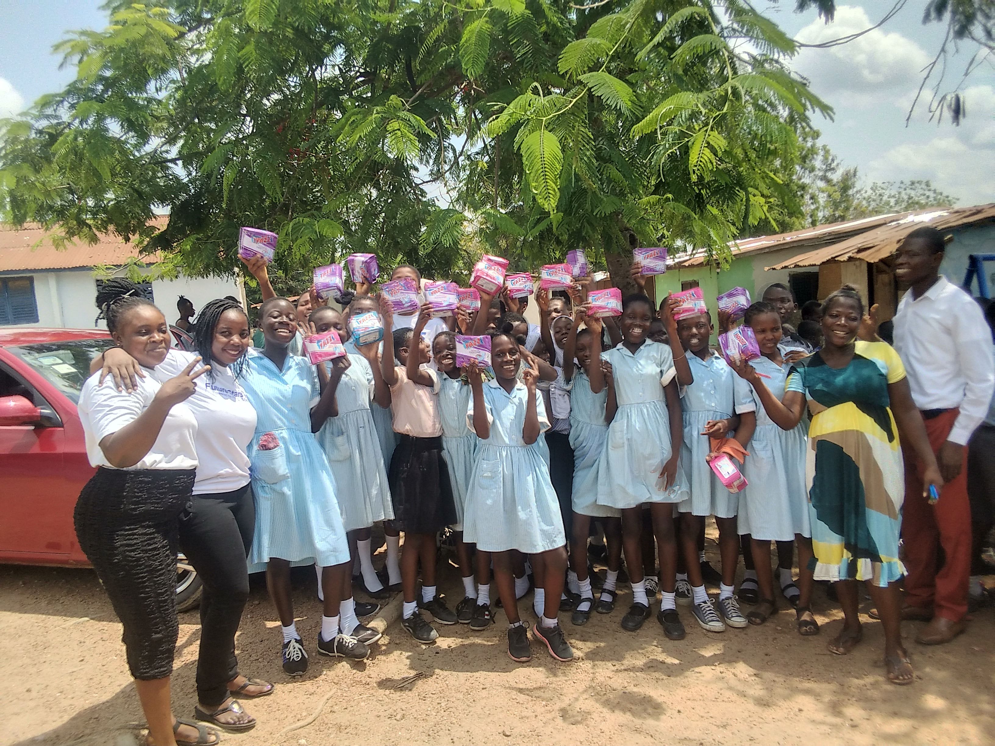 Girls holding sanitary pad donations